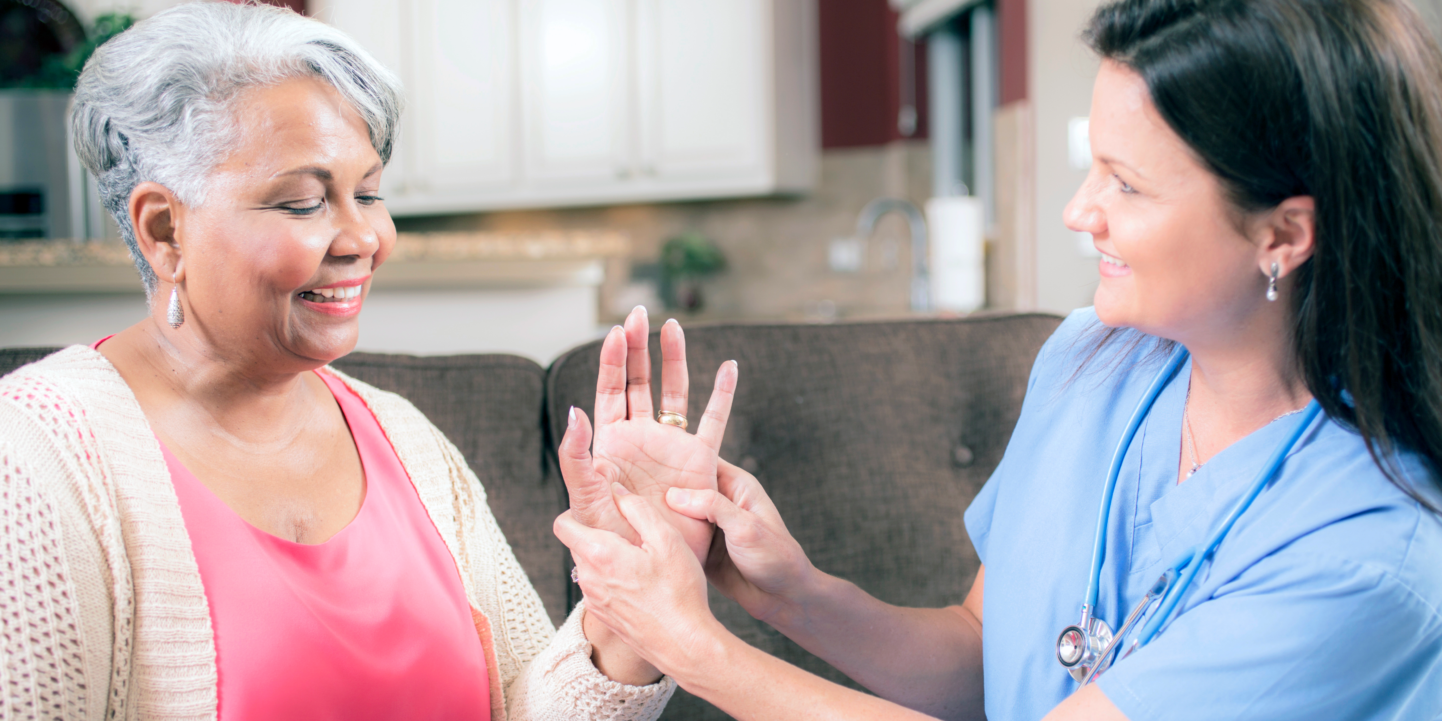 a doctor checking out a woman's hands.