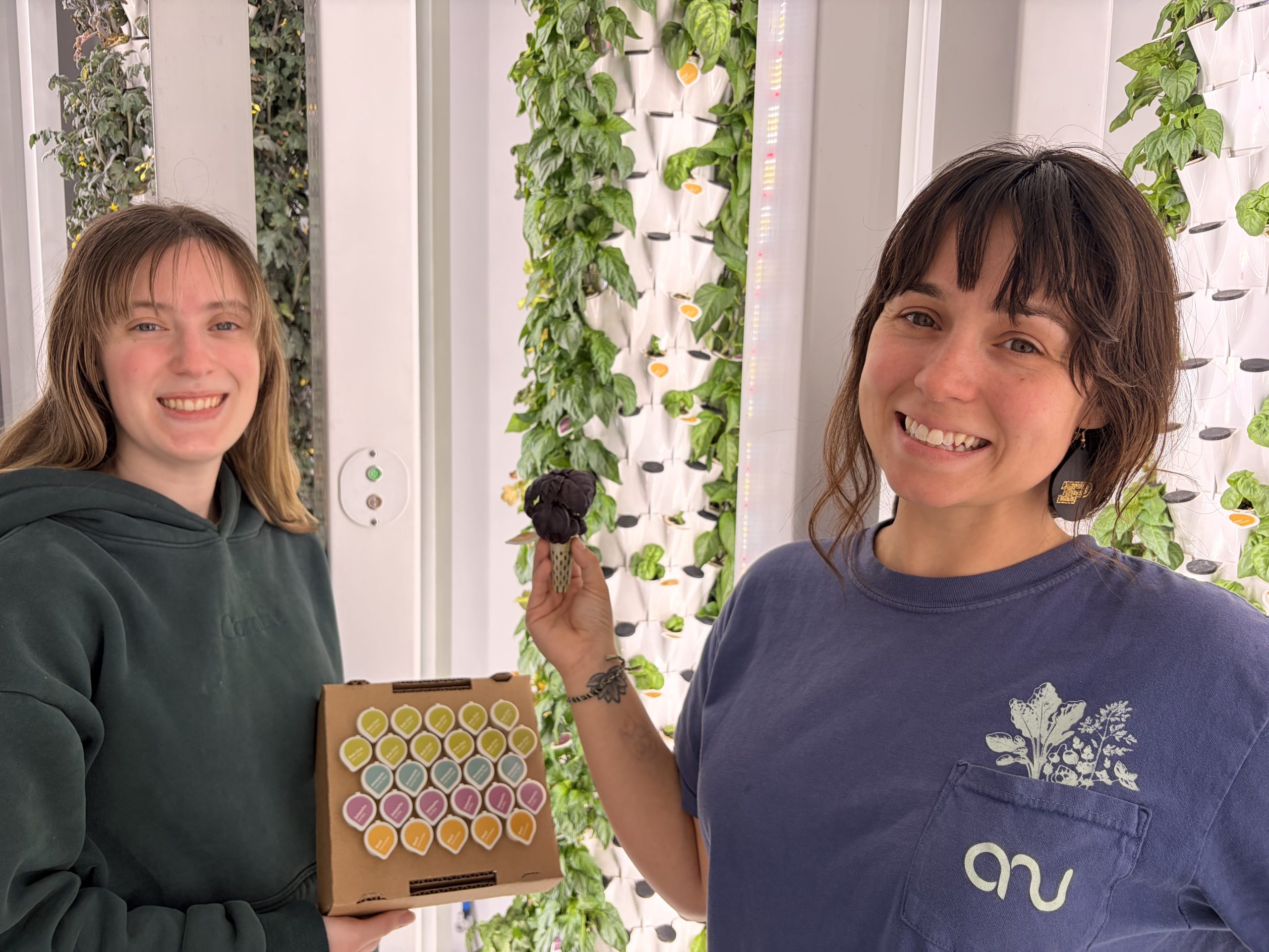 Anu team member Kaya Arnold, right, holds a lettuce Plug-and-Grow™ Seed Pod and Julia Morando, left, holds a 26-pack of seed pods. Anu has received a $500,000 Phase IIB SBIR grant from the National Science Foundation to advance its technology.